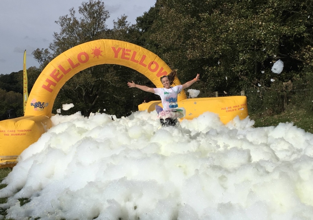 Girl jumps through yellow bubble station