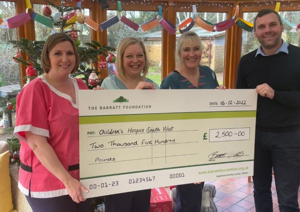 Little Bridge House Head of Care, Vicky Stuckey and care team members Jean Noall and Michelle North receive the cheque from Andrew Spicer, managing director for the Exeter division of Barratt David Wilson Homes