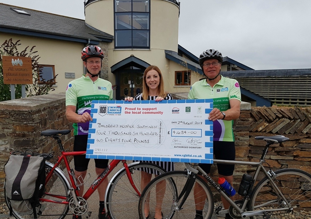 RGB cyclists present cheque at Children's Hospice South West