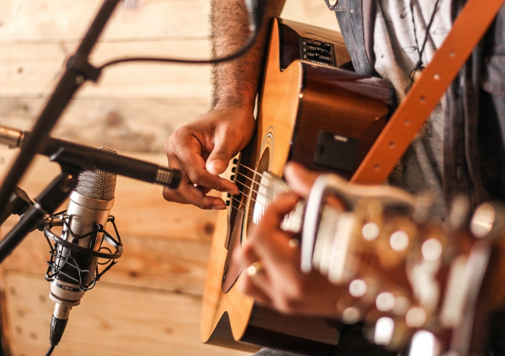 person-playing-acoustic-guitar