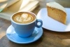 Coffee cup and saucer and slice of cake