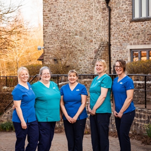Nurses standing outside a hospice building