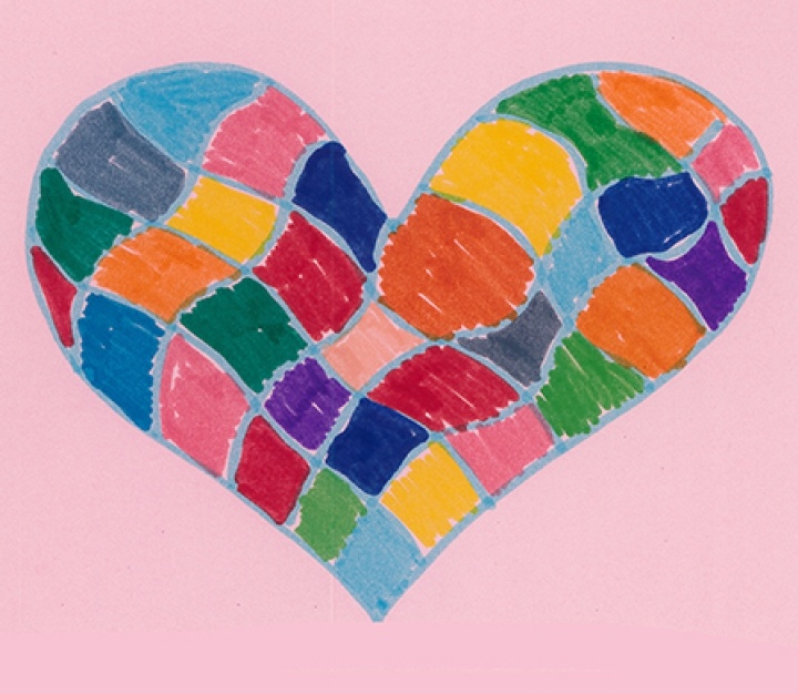 Child's colourful drawing of a heart on a pink background