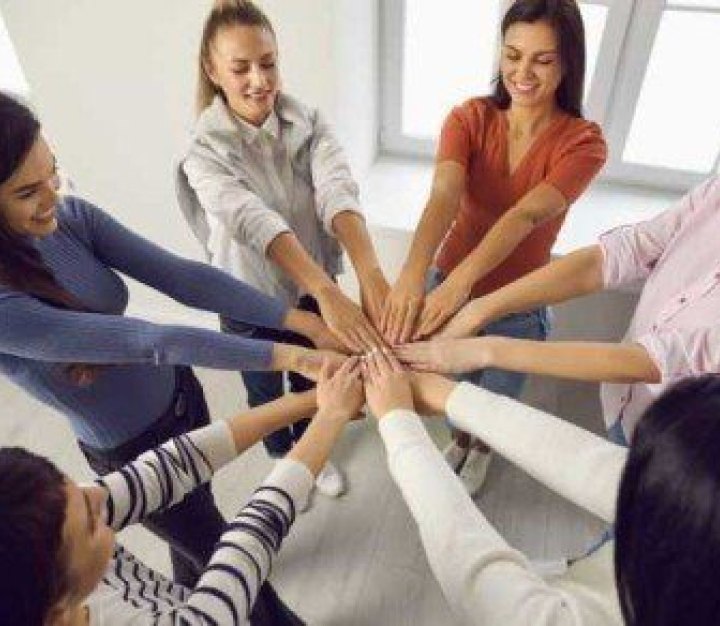 Team of people holding hands