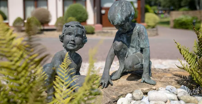 Statues of children outside