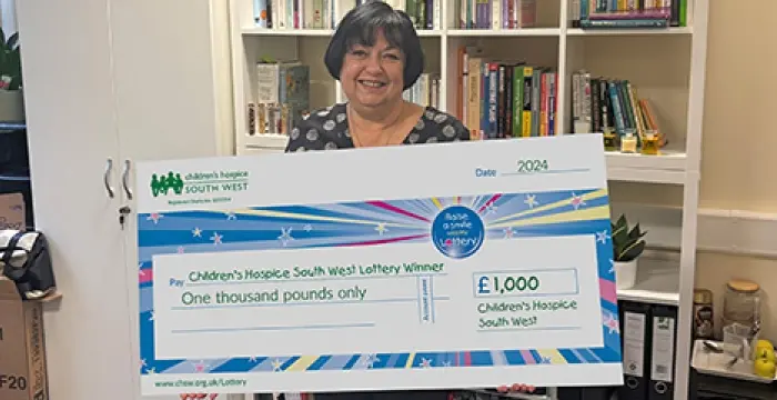 Lottery winner holding a big cheque