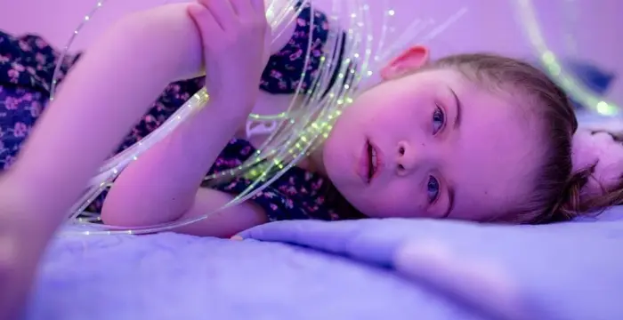 Girl lying on her side in the sensory room