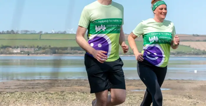 Man and woman running on the beach