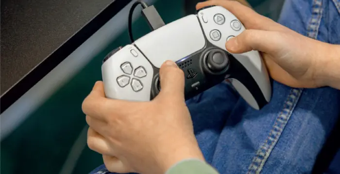 Hands holding a gaming controller