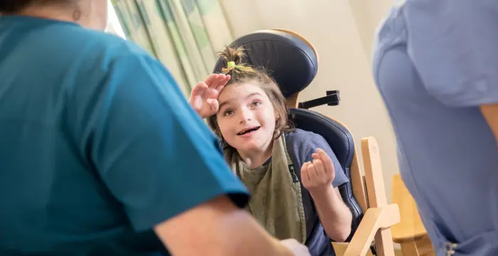 Girl smiling with carers