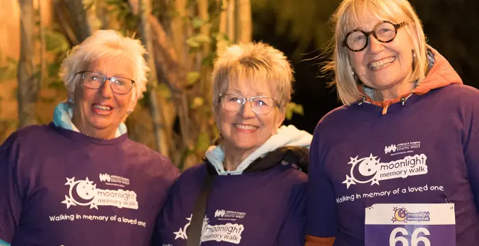 Three smiling women at Moonlight Memory Walk Clevedon