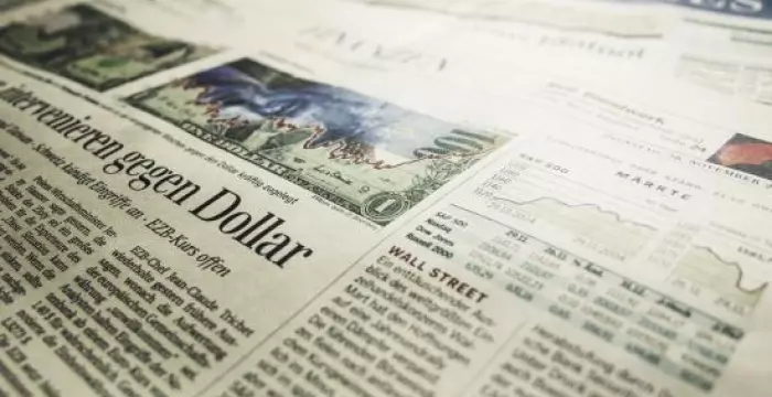 Newspaper showing stock market article