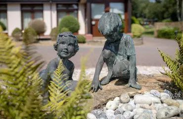 Statues of children outside