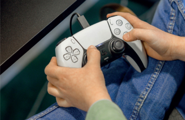 Hands holding a gaming controller