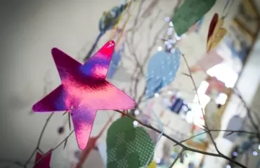 Pink star dedication hanging on a memory tree