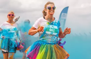 women getting covered in blue powder paint